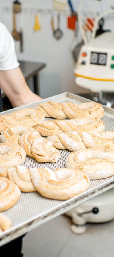 baker-with-tray-full-of-sweet-pastry-2023-11-27-05-19-34-utc